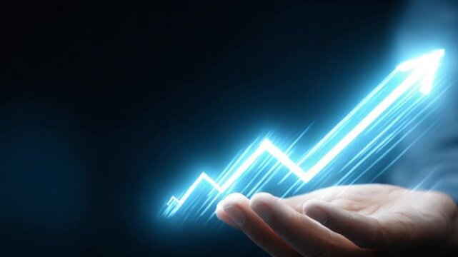 Hand holding a glowing upward trending graph