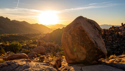 Tranquil Desert Sunset with a Large Boulder and Mountain Silhouettes