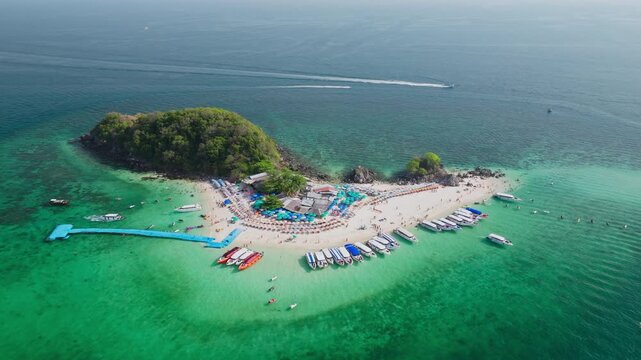 Aerial view of Koh Khai Nok island, where boats line the shore, contrasting with the island's lush greenery and turquoise waters, Phru Nai, Phang Nga, Thailand.