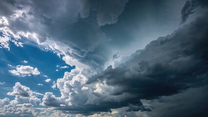 Obraz premium Dramatic storm clouds rolling over a bright summer sky.
