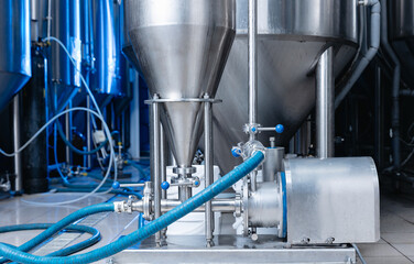 Industrial food pump in brewery fermentation tanks, process of mixing beer and juices to produce...