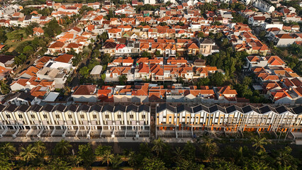 Naklejka premium Aerial drone view of densely populated urban neighborhood with narrow streets and compact housing. city planning, social documentaries, and urban development concept