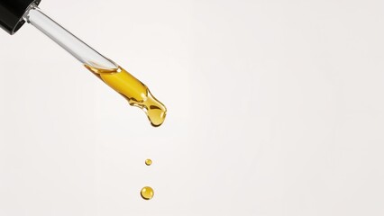 Beauty serum oil with pipette and drops, a natural cosmetic product focused on skin care and anti-aging effects on white background.