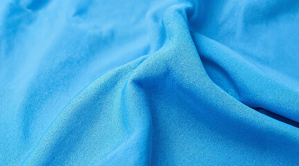Smooth blue fabric with soft texture displaying gentle folds  