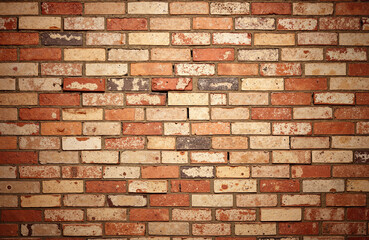 Red and beige brick wall with rustic texture and imperfections  