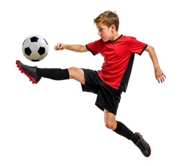 Young boy football player doing a kick in the air while jumping on isolated background