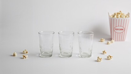 Three glasses with stripes arranged upside down against a white backdrop.
