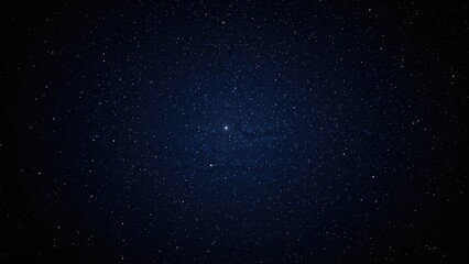 Fototapeta premium Wide view of a deep blue night sky dotted with stars against a dark backdrop