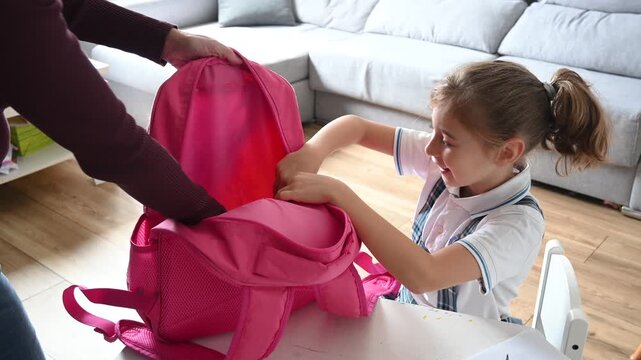 Mother Giving Lunch Box to Daughter on First Day of School
