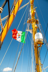 Brindisi, Italy - 10 July 2025: Italian flag flying on mast of Navy ship Palinuro docked in port