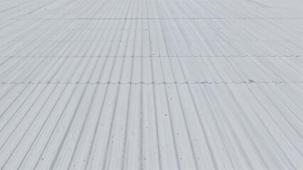 Panoramic image featuring white corrugated metal pattern and galvanized steel surface
