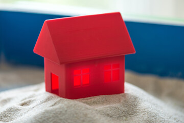 The concept of psychology. Sand
therapy. A red house in a blue sandbox.
Psychology. Therapy.