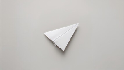 Naklejka premium Paper airplane leading on a neutral gray surface