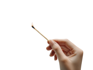 A hand delicately holds a burning match, the flickering flame a symbol of potential and the start of something new. 