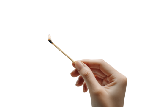 A hand delicately holds a burning match, the flickering flame a symbol of potential and the start of something new. 