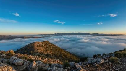 A stunning outlook from the highest point. Expansive panorama. Mountain shadows emerge through the early blue fog.