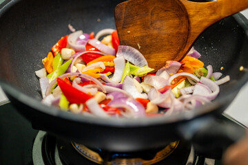 Culinary Skills cooking. Chef Expertly Stir-fries Vibrant Vegetables. Man mixing ingredient many vegetable.