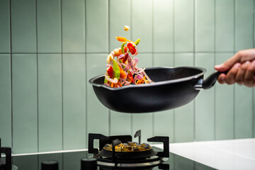 Culinary Skills cooking. Chef Expertly Stir-fries Vibrant Vegetables. Man mixing ingredient many vegetable.