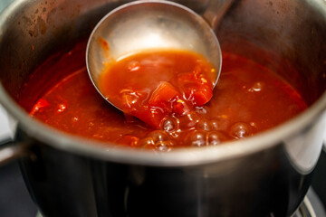 Rich tomato sauce simmer gently in a pot coat pasta. Thick vibrant tomato sauce bubbles in a pan filling the kitchen. Homemade tomato sauce bubbling beautifully on the stove awaits its pasta pairing
