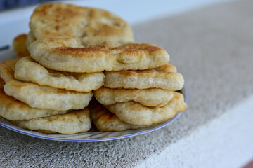 Traditional Bulgarian home made deep fried  patties  covered with sugar  оn rustic backgroud.Mekitsa or Mekica,  on wooden  rustic  background. Made of kneaded dough that is deep fried 