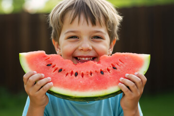 Happy boy eating a big slice of watermelon in summer. Smiling child enjoying a fresh juicy fruit snack outdoors.