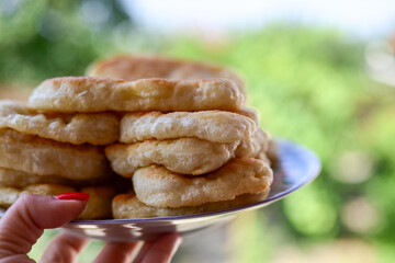 Traditional Bulgarian home made deep fried  patties  covered with sugar  оn rustic backgroud.Mekitsa or Mekica,  on wooden  rustic  background. Made of kneaded dough that is deep fried 
