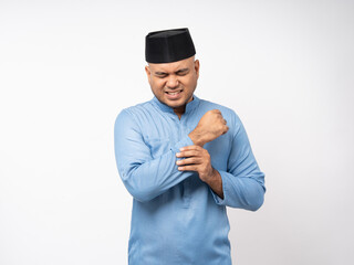 Asian muslim man has an inflamed arms and elbow. Islamic man has problem with structural posture.
