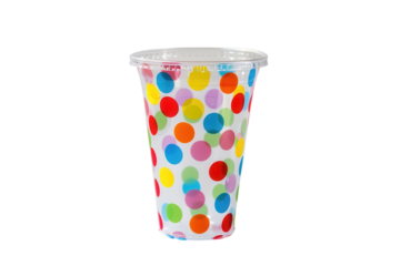Colorful polka dot cup filled with vibrant drink showcased in a sunny outdoor setting during a festive gathering
