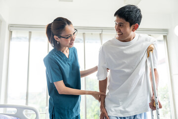 Fototapeta premium Physical therapy. Female Nurse aids young man in recovering from spine injury and providing orthopedic massage Orthopedic healthcare and chiropractor with person for physical therapy rehabilitation