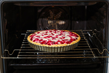 Closeup homemade cherry berry pie baked in a home oven. Shallow focus.