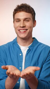 A captivating tight medium video of a bright-eyed, cheerful, young gender-neutral child (4-7) smiling, making a 'ta-da' gesture in a pristine studio with soft pastel bokeh background, pure joy and