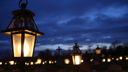Rows of traditional metal grave lanterns illuminated at twilight  