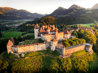 Drone View of Gruyères Castle at Sunset, Fribourg, Switzerland © JJ