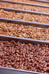 Selection of roasted nuts offered at a market stall