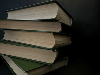Classic books with patina and timeworn textures on a dark background. Perfect for timeless knowledge, reading, and heritage visuals.