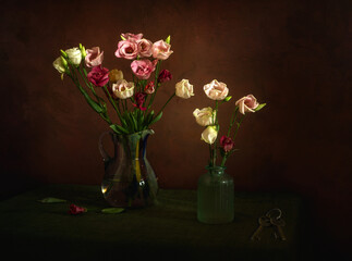 Still life with a small bouquet of blooming eustoma on a dark background. Minimalism.