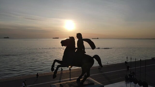Sunset at the seafront of the Greek city of Thessaloniki, with the silhouette of Alexander the Great statue.
