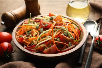 Tasty vegetable noodles served on wooden table, closeup
