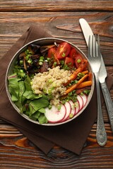 Healthy vegetarian food. Delicious Buddha bowl with quinoa, mushrooms and vegetables on wooden table, flat lay
