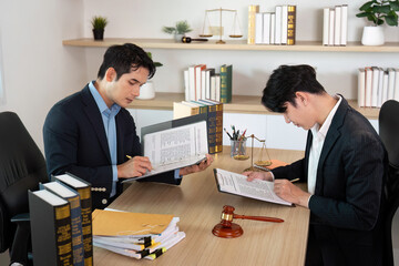 Contract Review. Lawyers reviewing documents in a law office setting.