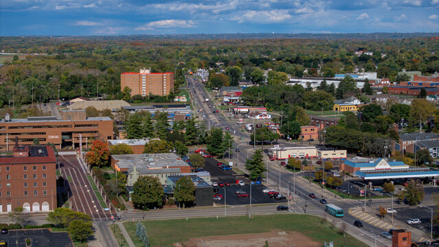 Aerial view of a bustling cityscape showcasing a blend of brick buildings, interspersed with verdant trees, alongside a long road, Middletown, Ohio, United States.
