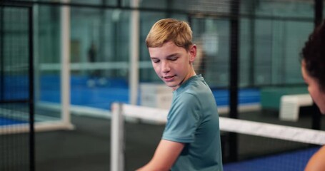 Woman, kid and court for padel lesson with instructions, demonstration and serve advice. Coach, help and teenager with racket guidance for technique, sports tips and learning skills for fitness game