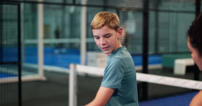 Woman, kid and court for padel lesson with instructions, demonstration and serve advice. Coach, help and teenager with racket guidance for technique, sports tips and learning skills for fitness game