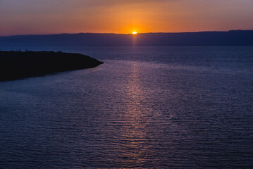 Sunset over Dead Sea salt lake seen from a Jordanian shore