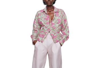Elegant fashion model posing gracefully in vibrant floral shirt and pants isolated on white background