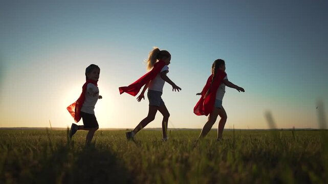 Children dressed as superheroes run in field. Superhero kids chasing dream outdoor. children red capes embrace superhero dream. childhood imagination in superhero play. Children living superhero dream