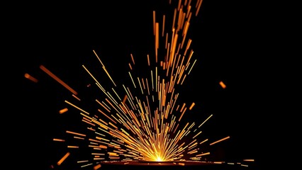 Bright orange sparks fly dynamically against a dark backdrop, evoking industrial metalwork energy.