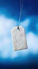 Vintage paper tag floating in blue space with abstract texture, minimalist design concept.