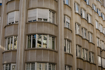 Modernist Architecture: Beige Building Exterior with Bay Windows and Closed Shutters, Urban,...