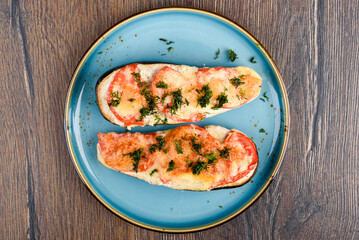 Top view of eggplants baked with cheese and tomatoes.